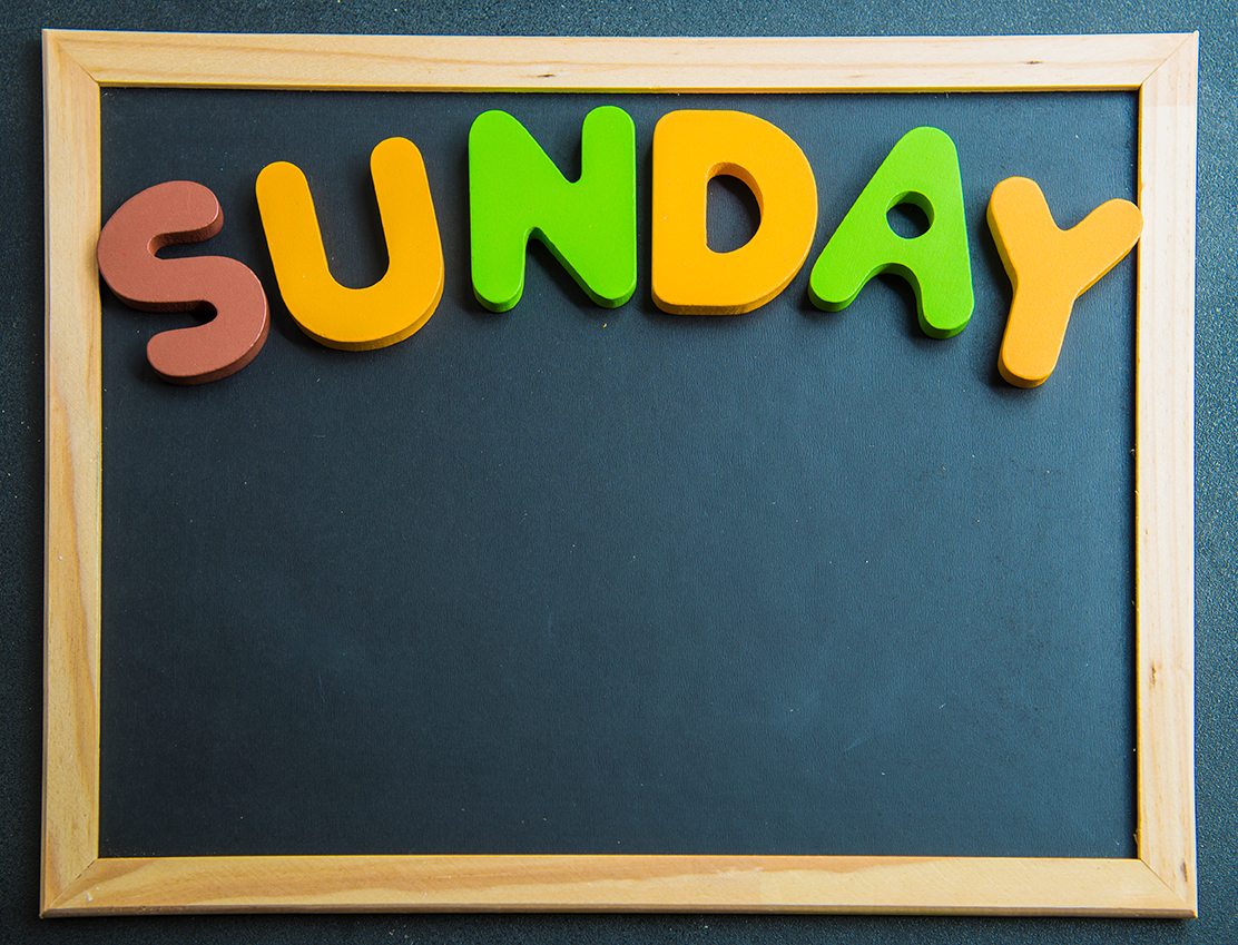 Colorful wooden word Sunday on black board