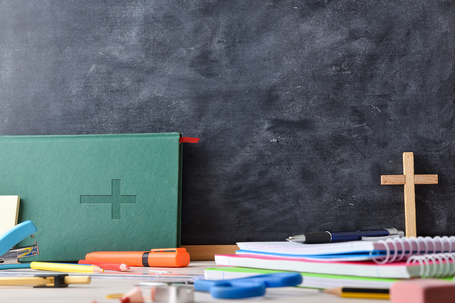 Educational background with blackboard, Bible and school supplie